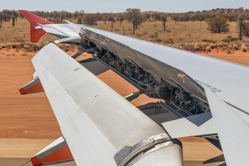 Airplane activates ground spoilers as it lands at Ayers Rock airport, Australia