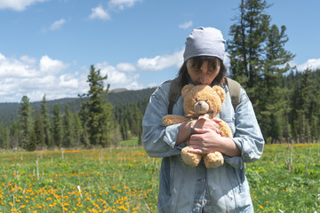 Unhappy woman with baby toy in her hands