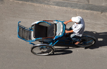 Man drive empty rickshaw - tricycle on the streets of Saigon, Vietnam.