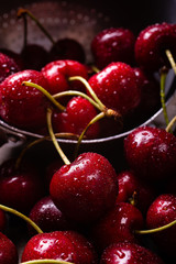 in the foreground of the fresh cherries covered with water droplets