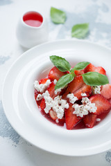 Closeup of strawberry dessert with addition of cottage cheese and sauce, selective focus