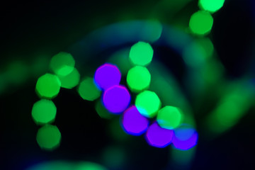 Blurred duotone bokeh lights spiral on black. Abstract background for your design
