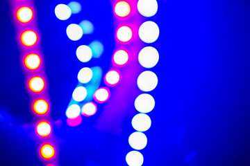Purple blue neon bokeh lights and reflections. Festive Abstract background of 80s colors