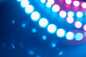 Duotone blue purple Bokeh lights curls and reflections. Festive background of 80s colors