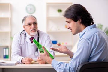 Young male alcoholic visiting old doctor  
