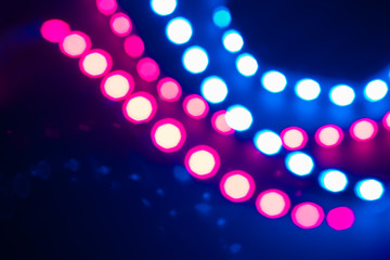 Duotone Abstract bokeh lights and reflections. Festive background of 80s colors