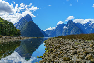 reflections of mountains in the water, milford sound, new zealand 42