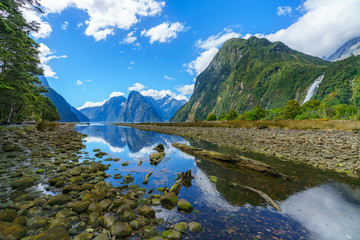 reflections of mountains and a waterfall, milford sound, new zealand 1