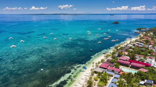 Aerial hyperlapse of boats around a busy tropical island beach (Malapascua, Philippines)