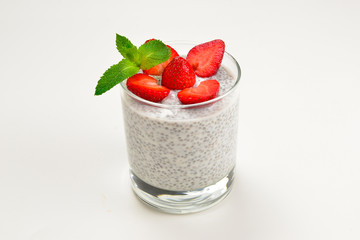 Chia pudding with strawberry and mint on a white background. Space for text or design.