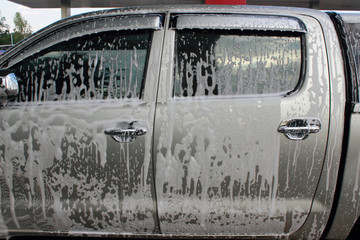 car wash foam on  pickup truck door © panupol
