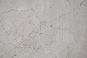 Concrete texture background with scratches, cracks and damage.