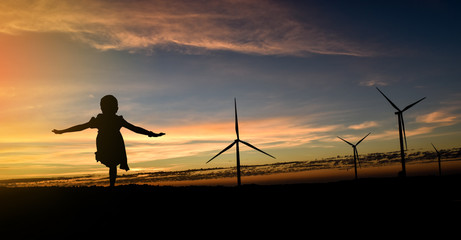Silhouette wind turbines at sunset © banphote