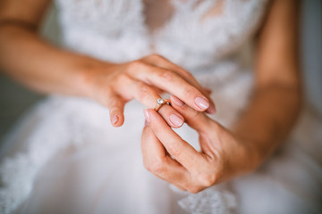 engagement ring in the hands of the bride