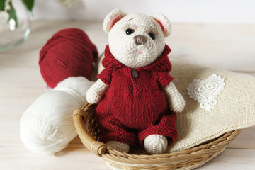 Knitted toy bear Handmade on wooden table. Crochet stuffed animals.