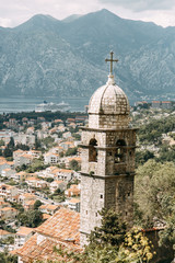 Fototapeta na wymiar Tiled roofs in Montenegro and Europe. Panorama of the city of Kotor from the height of the mountain.