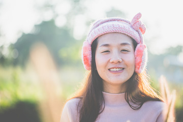 Spring - Beauty young woman outdoor enjoy nature, She put on the earmuff and breathed fresh air in the morning.