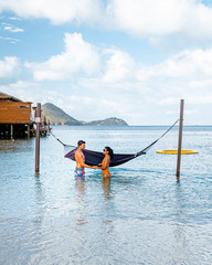 couple on luxury vatation at the tropical Island of Saint Lucia, men and woman by the beach and...