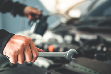 Technician Hands of car mechanic working in auto repair Service and Maintenance car