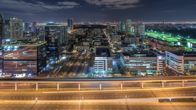 Tecom, Barsha and Greens districts aerial view from Internet city timelapse. Office and residential buildings from above. Traffic on highway and golf cource on a background