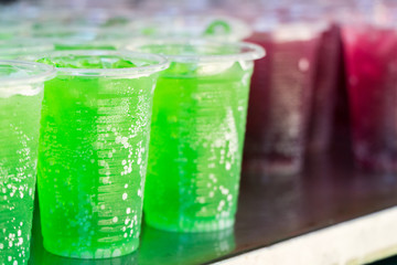 Green beverage in clear plastic glass