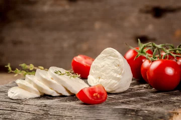 Foto op Plexiglas Mozzarella cheese, basil and tomato cherry on slate stone board, copy space. Ingredients for Caprese salad. Free space for your text © Надія Коваль