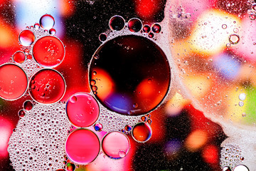 Pink and purple abstract pattern made with oil bubbles on water