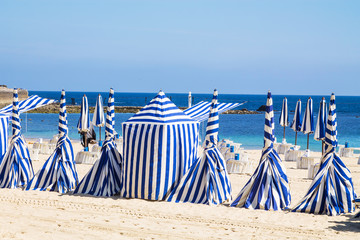 parasols, awnings, and booths on the beach