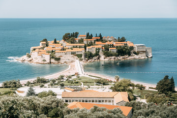 Atmospheric tourist views of the old town from the mountain. The picturesque coast of the island of Sveti Stefan.