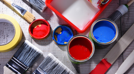 Paintbrushes of different size and paint can