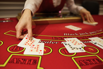 The croupier in the casino does a shuffle of cards