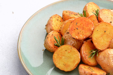 delicious baked potatoes on a rustic green plate.