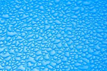 Drops of water on the wall with a new day. Closeup. Beautiful pattern for the surface background.