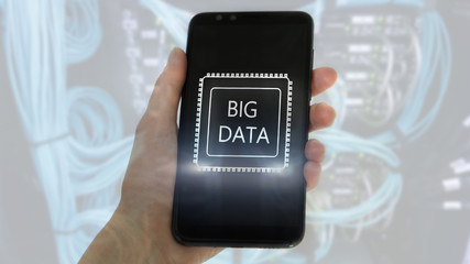 Big Data concept with hand holding modern smart phone. Server room background.