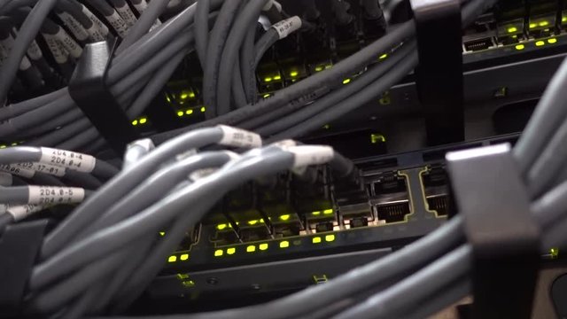 Network switch HUB and ethernet cables LAN in datacenter. The video contains small vibrations.