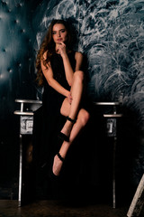 young gorgeous lady posing in lace dress, over black. space for copy