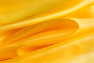 yellow bright fabric with large folds, abstract background