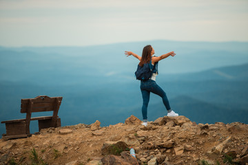 A healthy woman celebrates during a beautiful sunset. Happy and free. stand on the edge of the mountain. beautiful mountain.