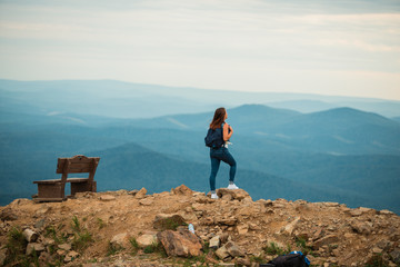 A healthy woman celebrates during a beautiful sunset. Happy and free. stand on the edge of the mountain. beautiful mountain.