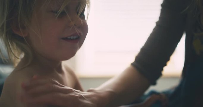 Mother applying cream to her toddler's eczema