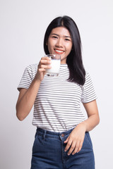 Healthy Asian woman drinking a glass of milk.