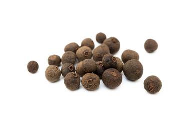 Scattered allspice isolated on white background