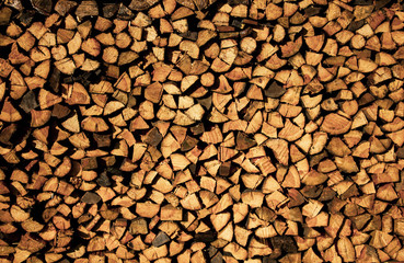 Firewood stacked. Wooden background. Wooden texture. The firewood neatly in the village