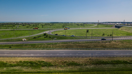 Fototapeta na wymiar Aerial view of modern highway road intersection on rural landscape