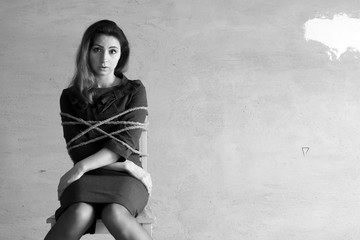 monochrome photo of a business woman sitting on chair associated workaholic concept