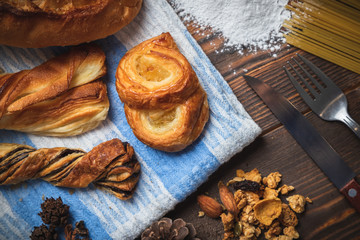 Freshly baked crusty loaves of bread  with flour on a wooden table.