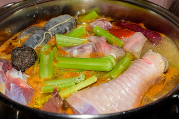 Traditional Spanish pork and chiken stew with blood sausage. Nutrition concept.