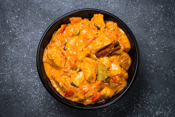 Chicken tikka masala on black top view.