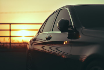 luxury business car closeup on sunset