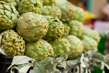 Fresh artichokes on market counter